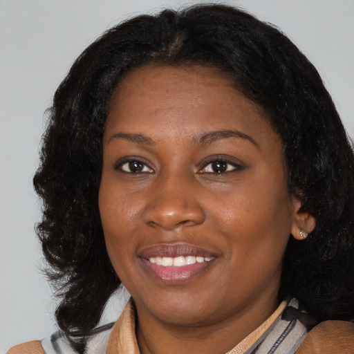 Joyful black young-adult female with medium  brown hair and brown eyes