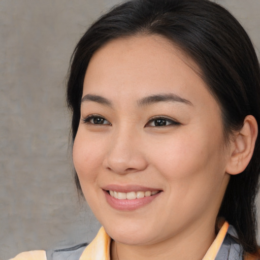 Joyful asian young-adult female with medium  brown hair and brown eyes