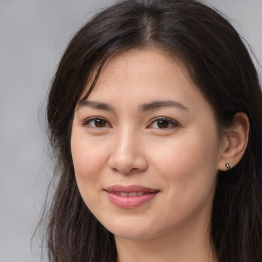 Joyful white young-adult female with long  brown hair and brown eyes