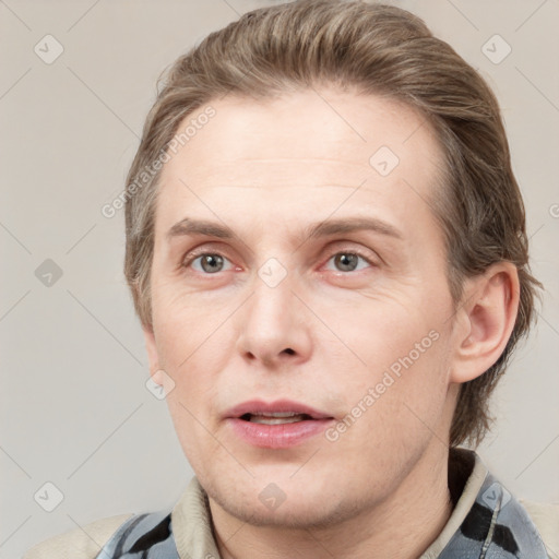 Joyful white adult male with short  brown hair and grey eyes