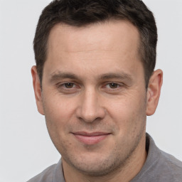 Joyful white adult male with short  brown hair and brown eyes