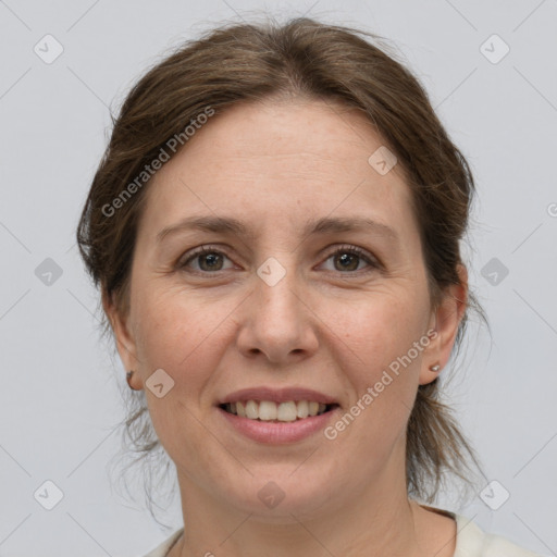 Joyful white adult female with medium  brown hair and grey eyes