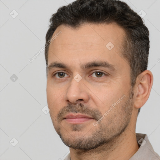 Joyful white adult male with short  brown hair and brown eyes