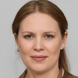 Joyful white adult female with medium  brown hair and grey eyes