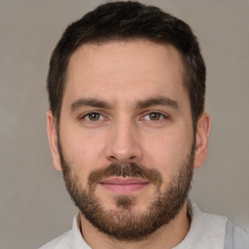 Joyful white young-adult male with short  brown hair and brown eyes