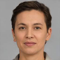 Joyful white adult female with short  brown hair and brown eyes