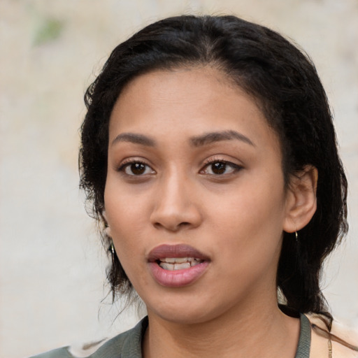 Joyful latino young-adult female with medium  black hair and brown eyes