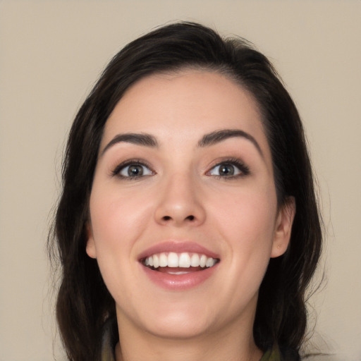 Joyful white young-adult female with long  black hair and brown eyes