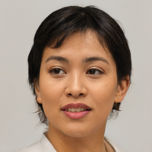 Joyful asian young-adult female with medium  brown hair and brown eyes
