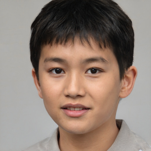 Joyful asian child male with short  brown hair and brown eyes