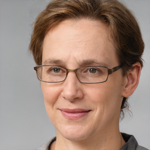 Joyful white adult female with short  brown hair and grey eyes