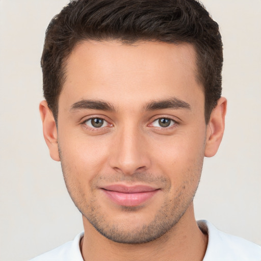 Joyful white young-adult male with short  brown hair and brown eyes