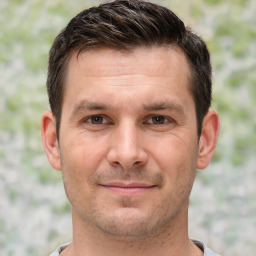 Joyful white adult male with short  brown hair and brown eyes