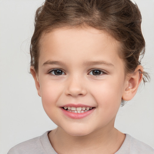 Joyful white child female with short  brown hair and brown eyes