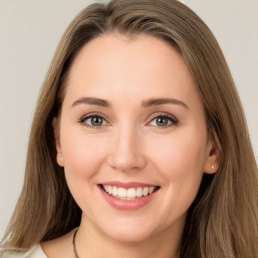 Joyful white young-adult female with long  brown hair and brown eyes