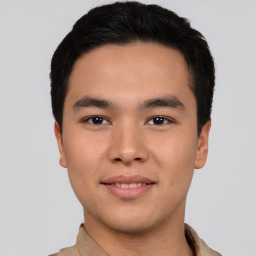 Joyful asian young-adult male with short  black hair and brown eyes