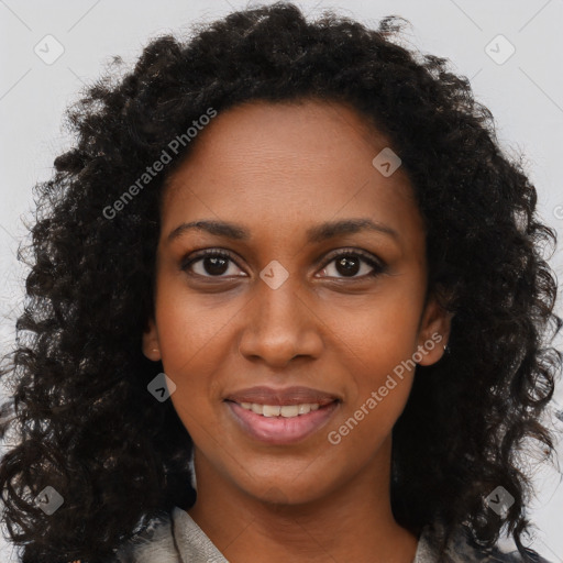 Joyful black young-adult female with long  brown hair and brown eyes