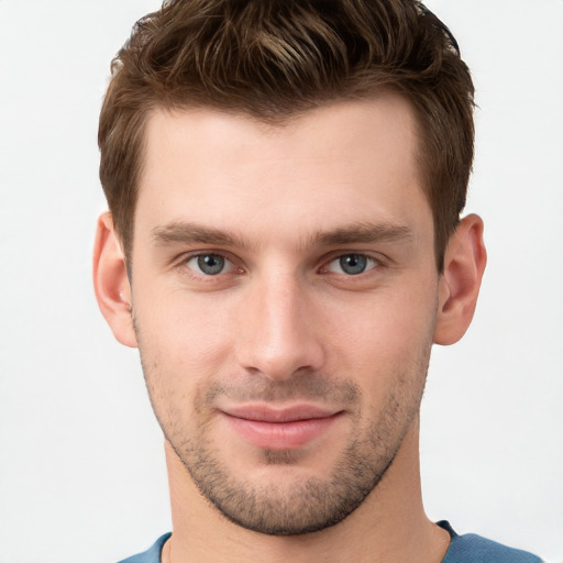 Joyful white young-adult male with short  brown hair and grey eyes