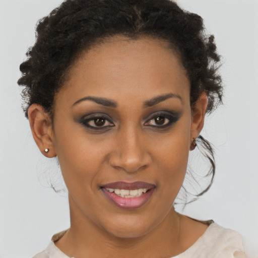 Joyful black young-adult female with short  brown hair and brown eyes