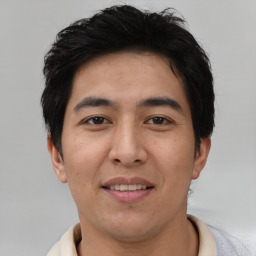 Joyful asian young-adult male with short  brown hair and brown eyes