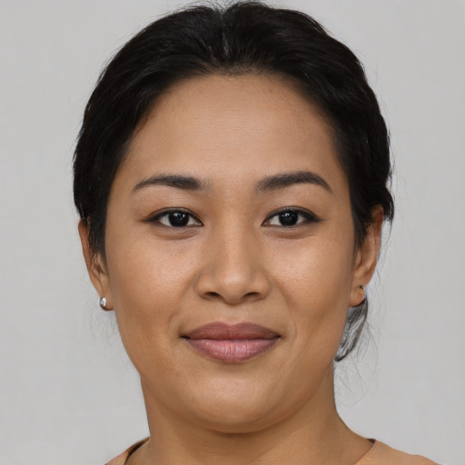 Joyful asian young-adult female with medium  brown hair and brown eyes