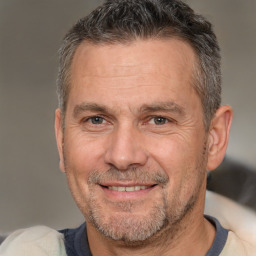 Joyful white middle-aged male with short  brown hair and brown eyes