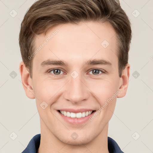 Joyful white young-adult male with short  brown hair and grey eyes