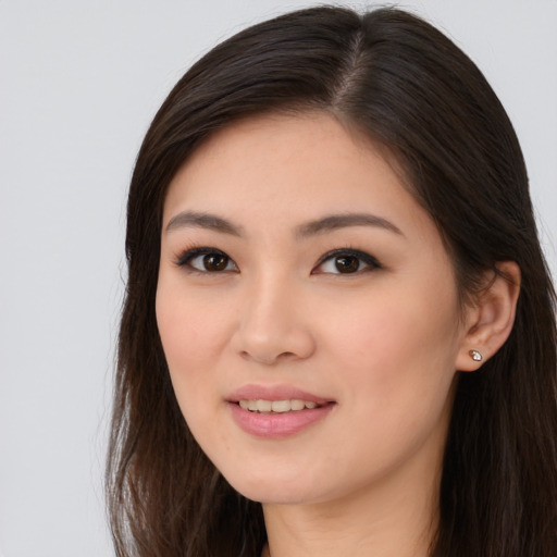 Joyful asian young-adult female with long  brown hair and brown eyes