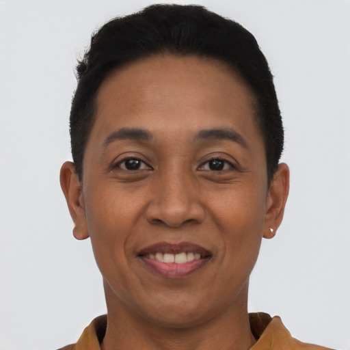 Joyful latino young-adult female with short  black hair and brown eyes