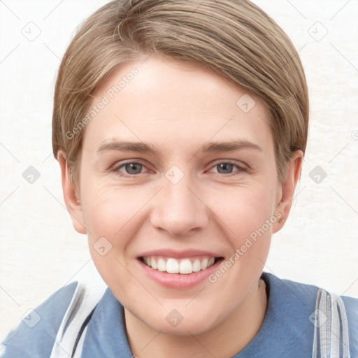 Joyful white young-adult female with short  brown hair and blue eyes