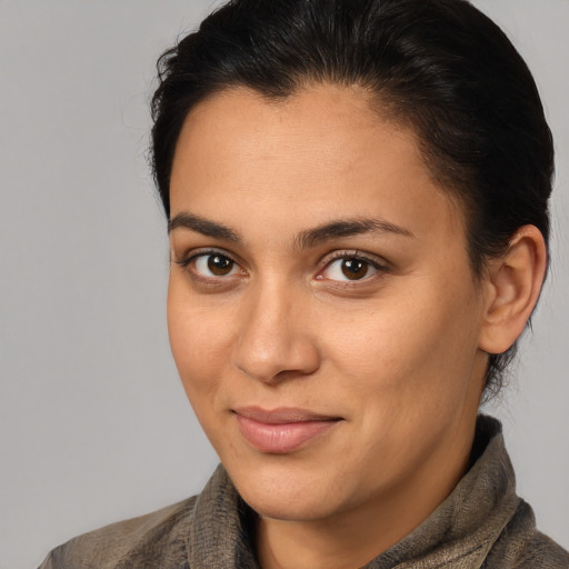Joyful latino young-adult female with medium  brown hair and brown eyes