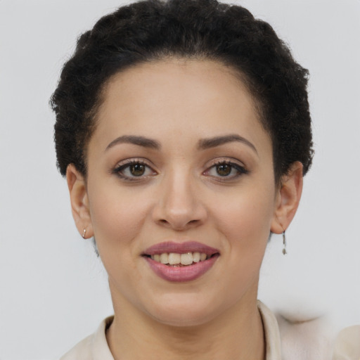 Joyful latino young-adult female with short  brown hair and brown eyes