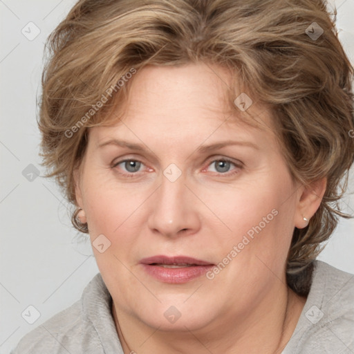 Joyful white adult female with medium  brown hair and blue eyes