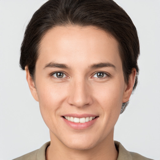 Joyful white young-adult female with short  brown hair and brown eyes