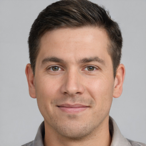 Joyful white adult male with short  brown hair and brown eyes