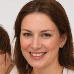 Joyful white adult female with medium  brown hair and brown eyes