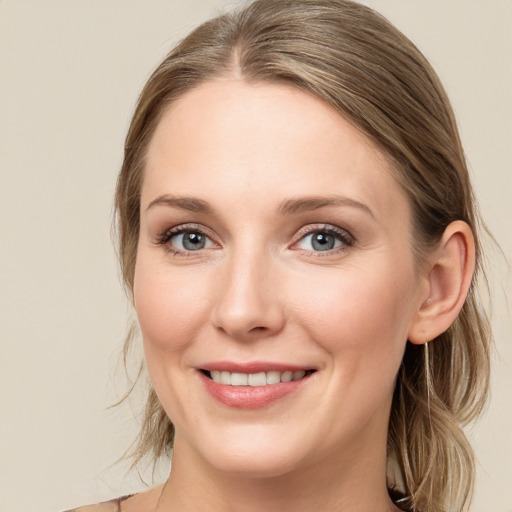 Joyful white young-adult female with medium  brown hair and blue eyes