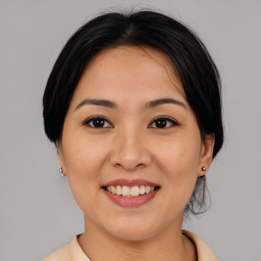 Joyful asian young-adult female with medium  brown hair and brown eyes