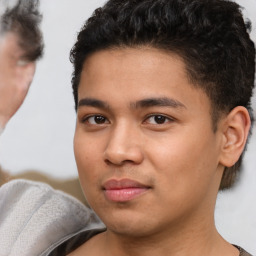 Joyful latino young-adult male with short  brown hair and brown eyes