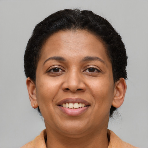 Joyful latino young-adult female with short  brown hair and brown eyes