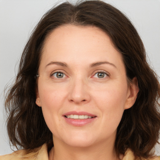 Joyful white adult female with medium  brown hair and brown eyes