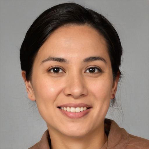Joyful white young-adult female with medium  black hair and brown eyes