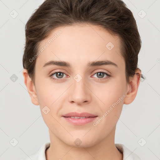 Joyful white young-adult female with short  brown hair and grey eyes