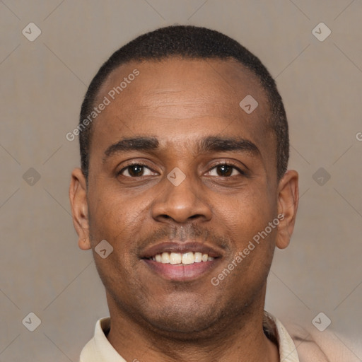 Joyful black young-adult male with short  brown hair and brown eyes