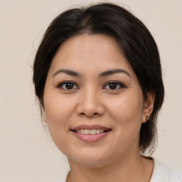 Joyful latino young-adult female with medium  brown hair and brown eyes