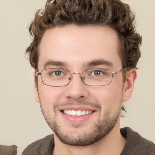 Joyful white young-adult male with short  brown hair and green eyes