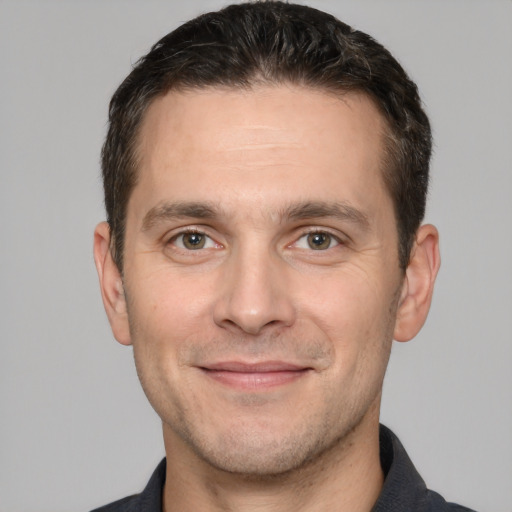 Joyful white adult male with short  brown hair and brown eyes