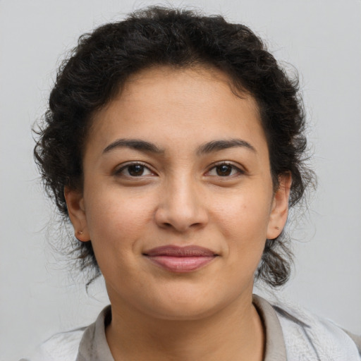 Joyful latino young-adult female with short  brown hair and brown eyes