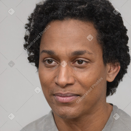 Joyful black adult male with short  black hair and brown eyes