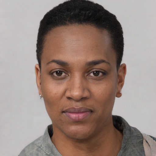 Joyful black young-adult female with short  black hair and brown eyes